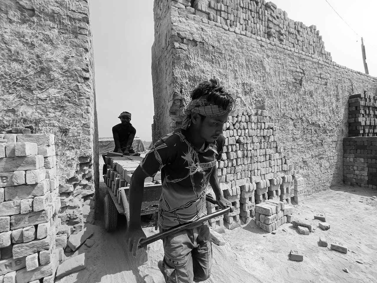 our-story Laborers transporting bricks at an outdoor kiln in Chandpur, Bangladesh.