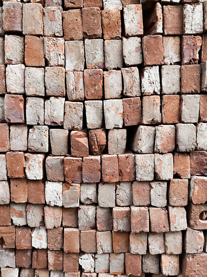 Detailed view of stacked red and white bricks showcasing natural texture and pattern.